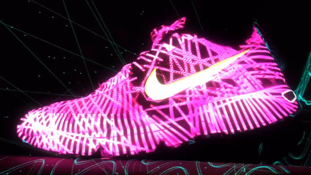 Projection-mapped neon trainer glowing in the dark.