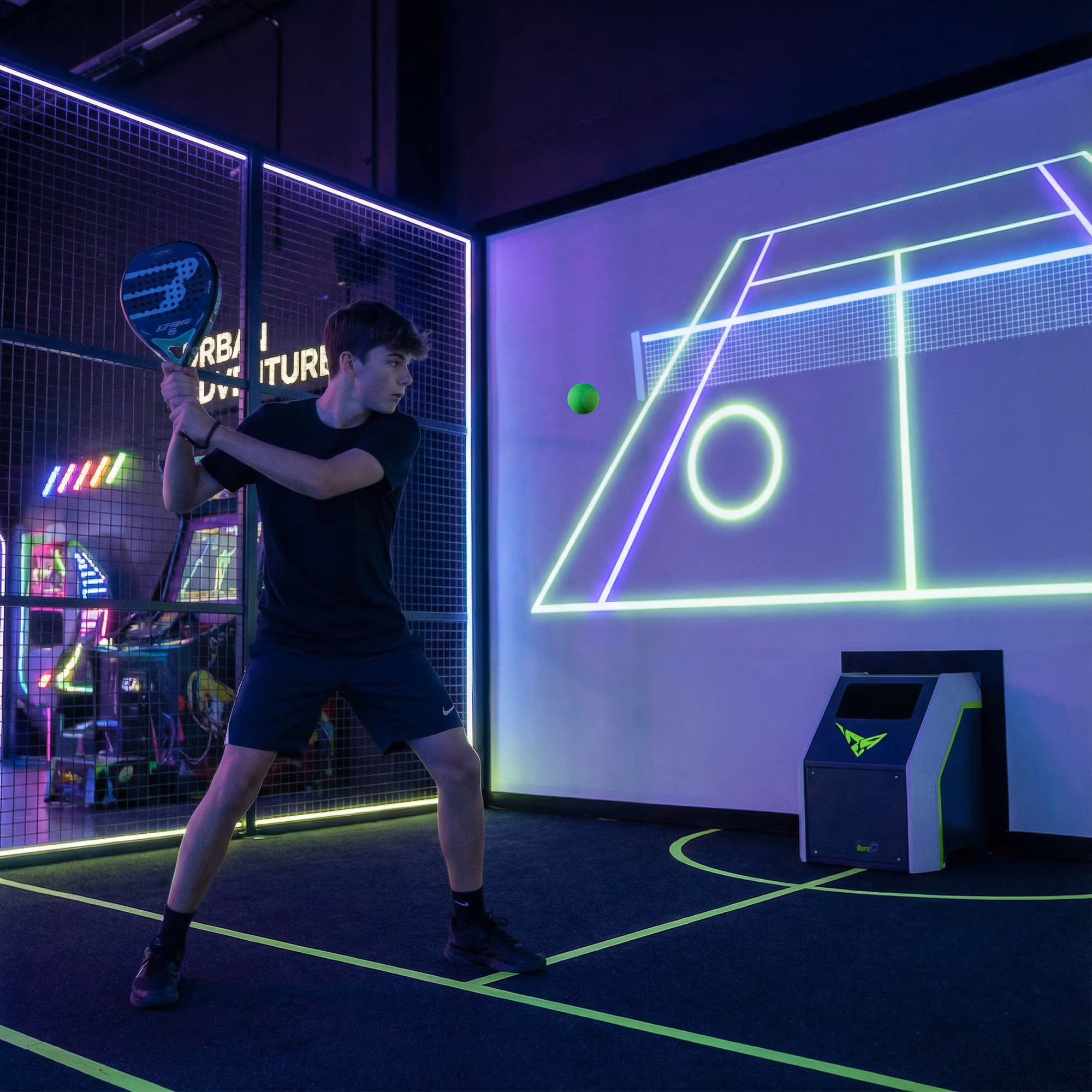 Player inside a neon, motion-reactive floor game.