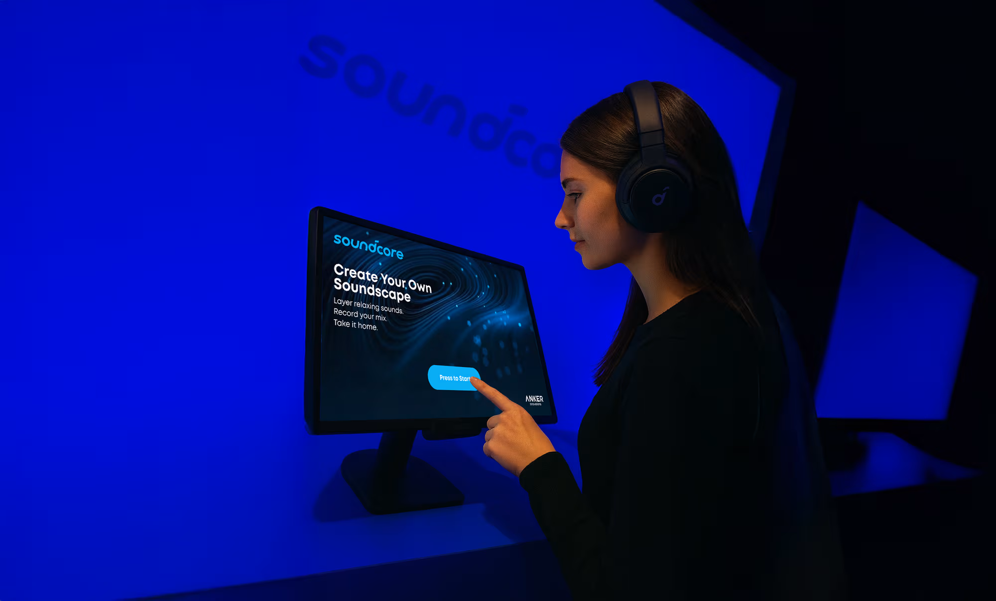 Visitor in a soundcore activation creating their own soundscape on a touchscreen.
